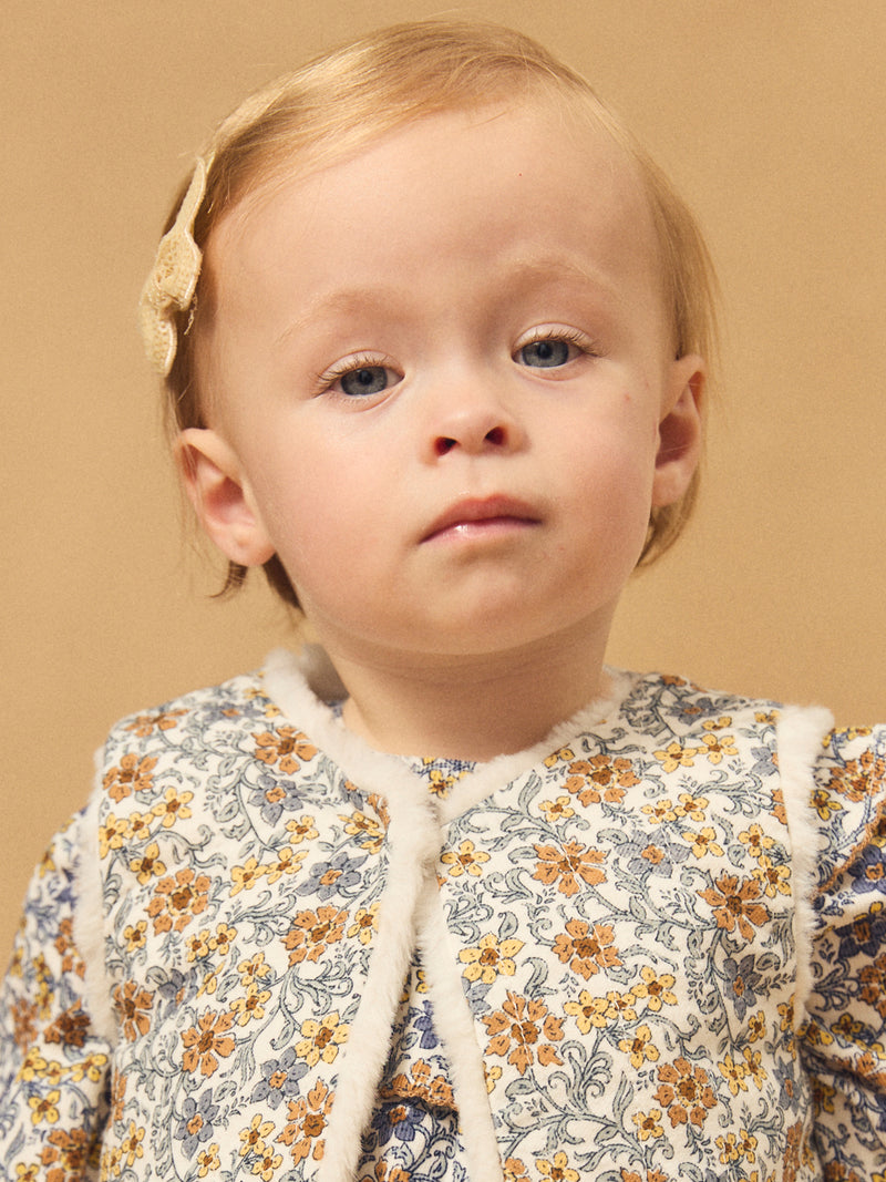 Gilet réversible blanc en fourrure ou imprimé fleuri Bébé Fille
